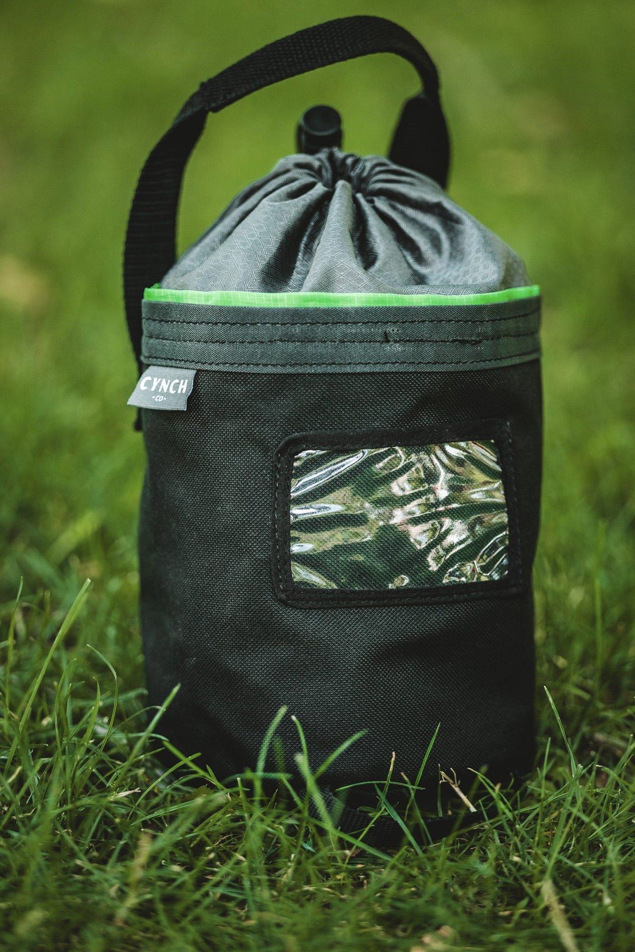Green-trim CYNCH bag standing in the grass