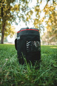 Thumbnail for Red-trim CYNCH bag in a park