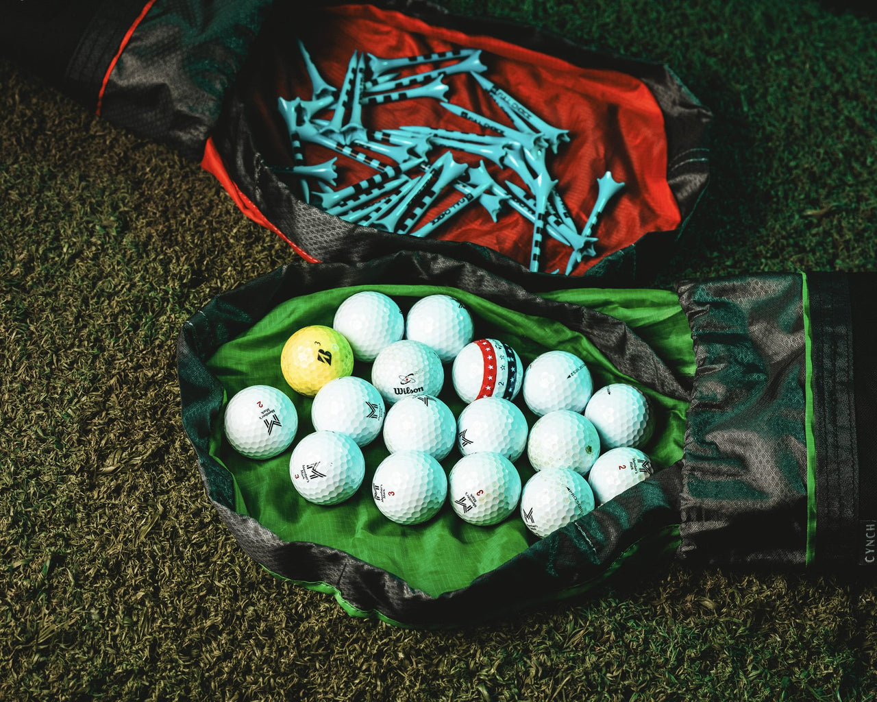 Green CYNCH sorting mat holding golf balls and tees