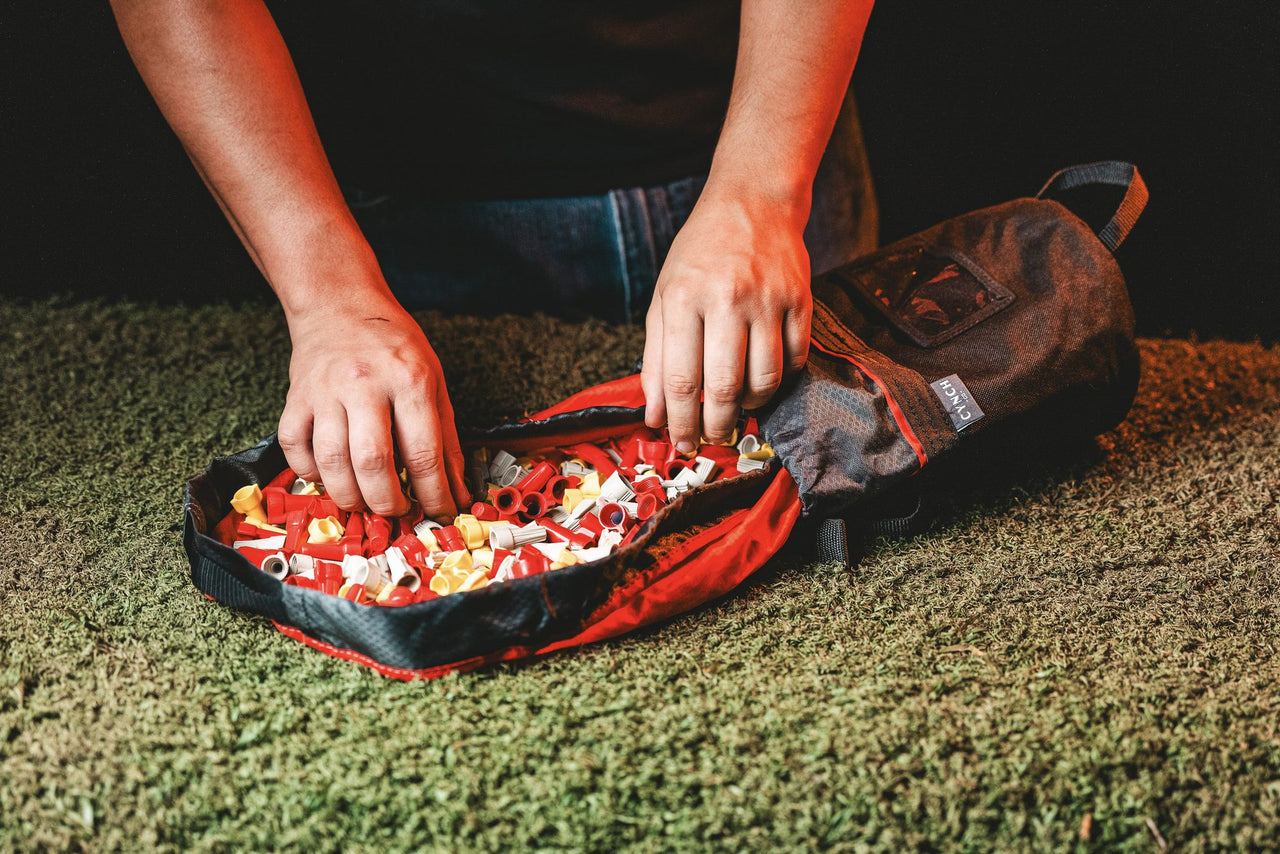 Hands sorting parts on an open CYNCH mat